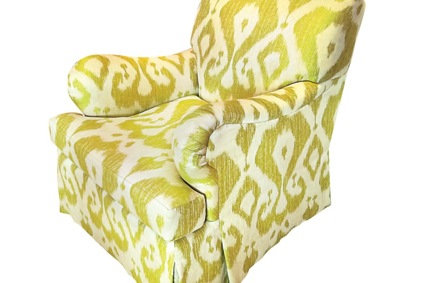 Green and white patterned armchair with a plush design on a white background.