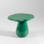 Green mushroom-shaped ceramic table with a glossy finish on a plain white background.
