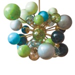 Modern chandelier with colorful glass spheres, featuring shades of green, blue, and clear, on a gold fixture.