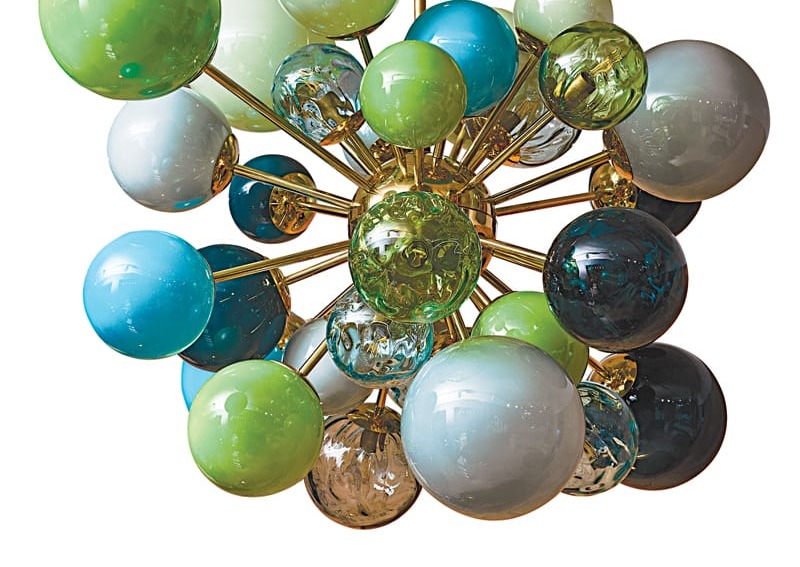 Modern chandelier with colorful glass spheres, featuring shades of green, blue, and clear, on a gold fixture.