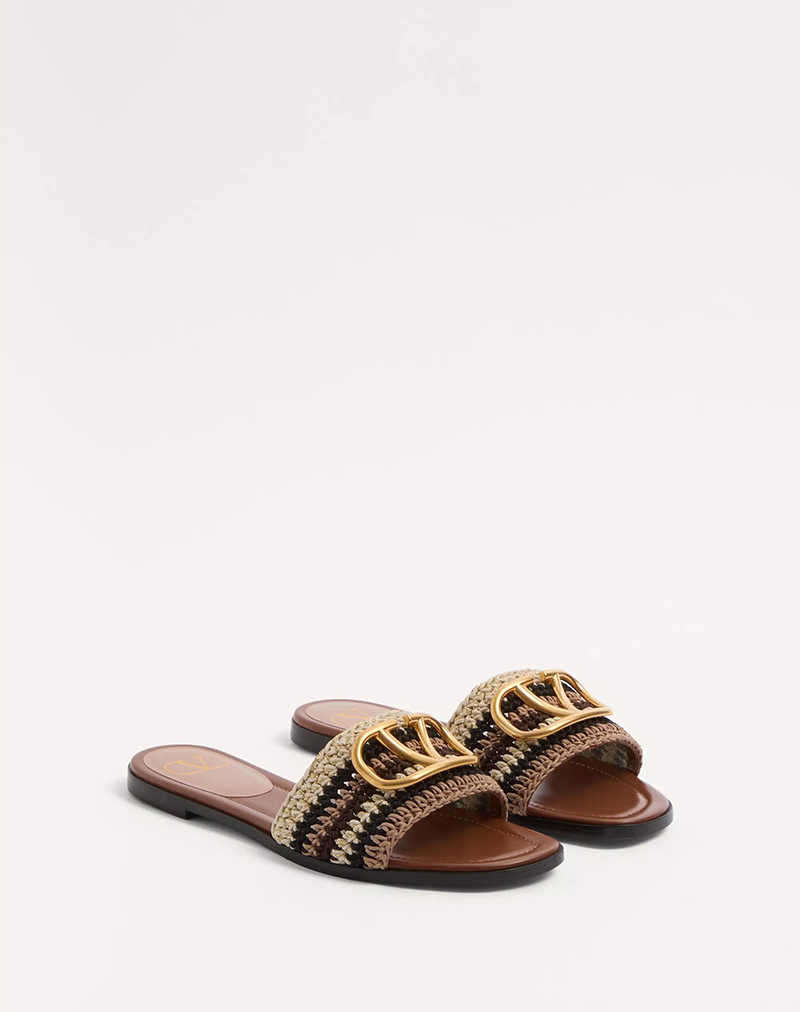 Vlogo signature slide sandals with crochet embroidery by Valentino.